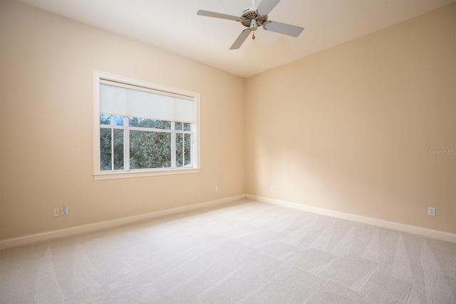 empty room with light colored carpet and ceiling fan