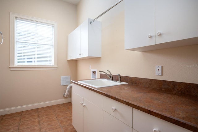 clothes washing area with cabinets, light tile patterned floors, sink, and hookup for a washing machine