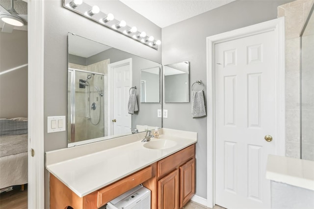 bathroom featuring vanity and a shower with shower door