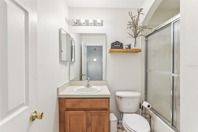 full bathroom with vanity, toilet, and shower / bath combination with glass door