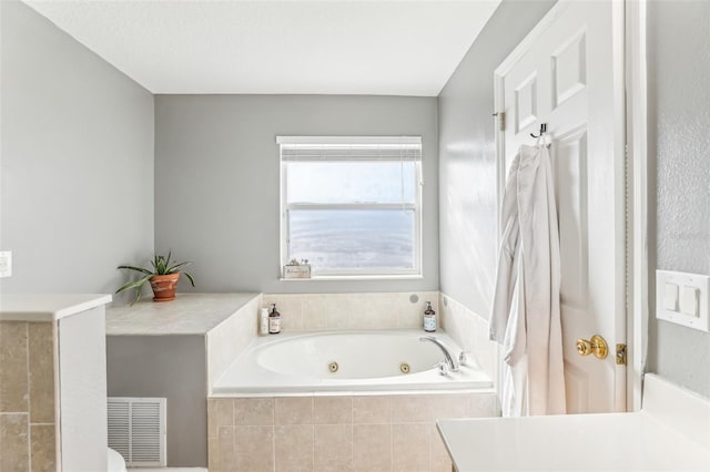 bathroom with a relaxing tiled tub