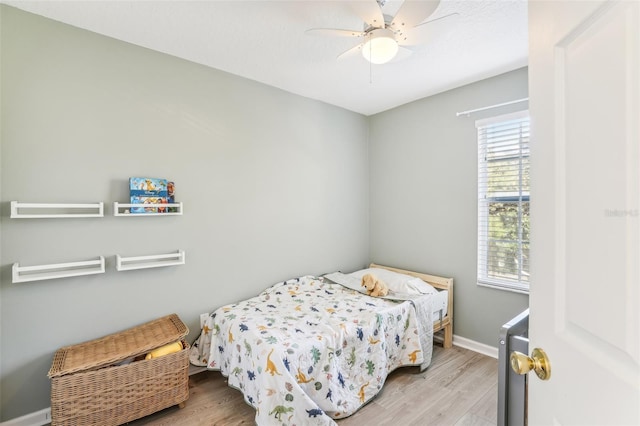 bedroom with light hardwood / wood-style floors and ceiling fan