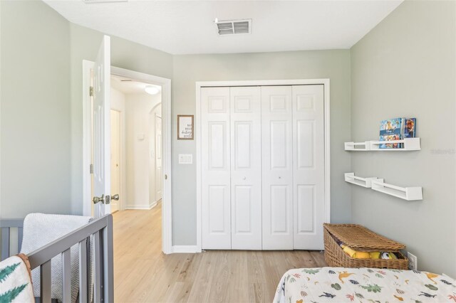 bedroom with a closet and light hardwood / wood-style floors