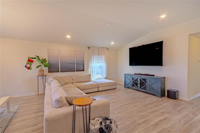 living room with light wood-type flooring and lofted ceiling