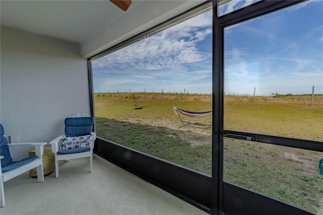 sunroom featuring a rural view