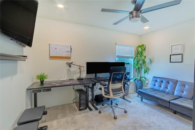 carpeted home office featuring ceiling fan