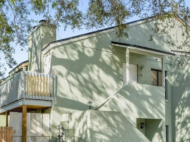 view of side of property featuring a balcony