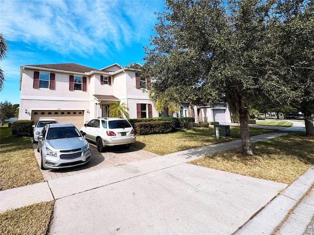 view of front of home with a garage and a front lawn