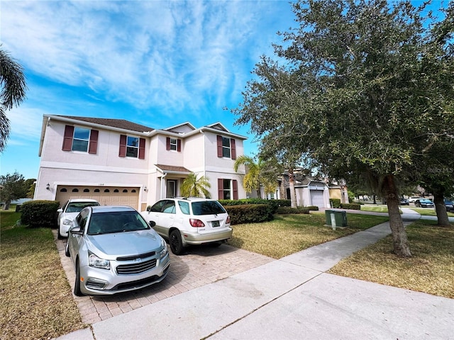 view of front of home with a garage and a front yard