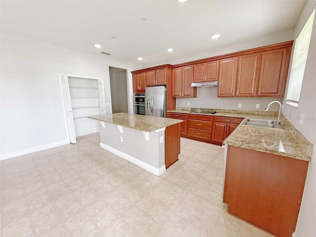 1208 Sawgrass Pointe Dr, Orlando, FL 32824 - kitchen featuring a center island, a sink, stainless steel appliances, light stone countertops, and under cabinet range hood