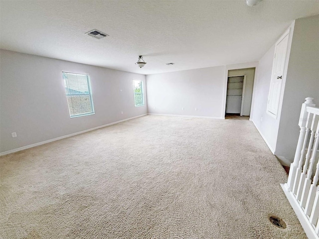 1208 Sawgrass Pointe Dr, Orlando, FL 32824 - empty room featuring carpet flooring, a textured ceiling, visible vents, and baseboards