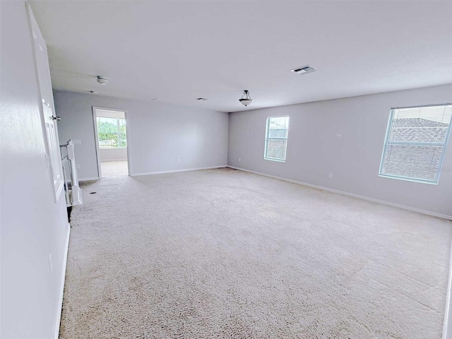 1208 Sawgrass Pointe Dr, Orlando, FL 32824 - empty room featuring light colored carpet, baseboards, and visible vents