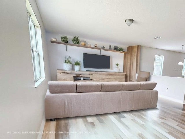 1208 Sawgrass Pointe Dr, Orlando, FL 32824 - living area featuring wood finished floors, visible vents, and baseboards