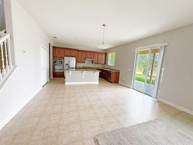 1208 Sawgrass Pointe Dr, Orlando, FL 32824 - kitchen featuring a center island, pendant lighting, stainless steel fridge with ice dispenser, baseboards, and light countertops