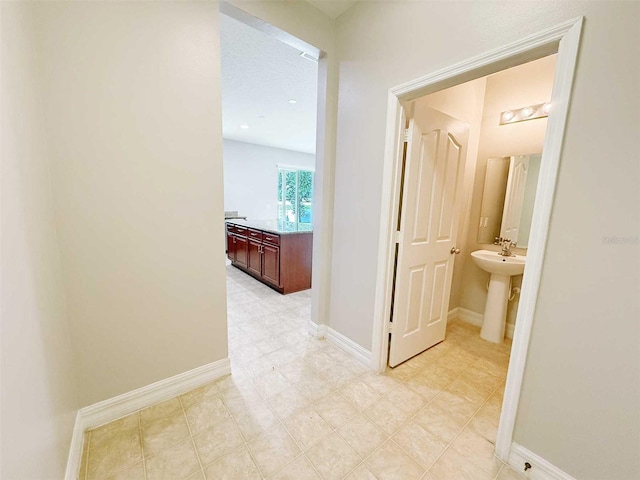 1208 Sawgrass Pointe Dr, Orlando, FL 32824 - hallway featuring a sink and baseboards