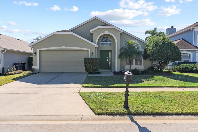 view of front of house with a garage and a front lawn