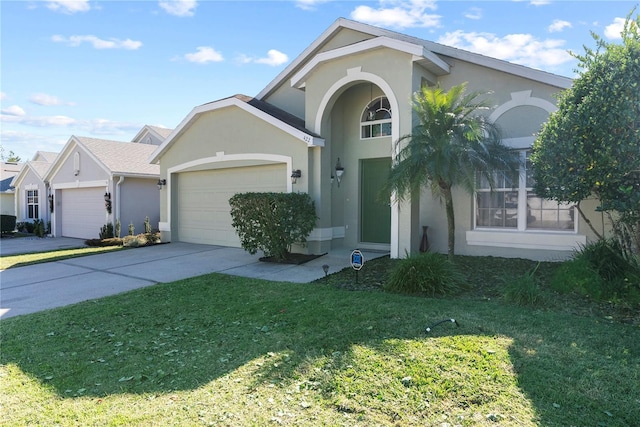 view of front of property featuring a front yard and a garage