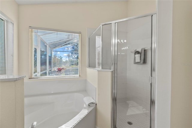 bathroom featuring independent shower and bath