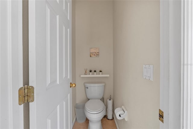 bathroom with tile patterned flooring and toilet