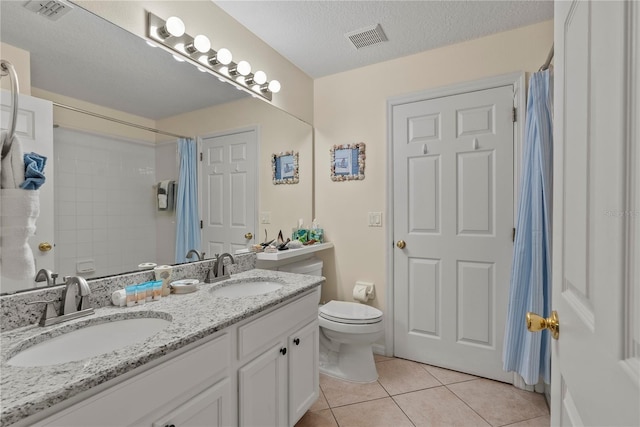 bathroom featuring tile patterned flooring, a textured ceiling, toilet, vanity, and a shower with shower curtain