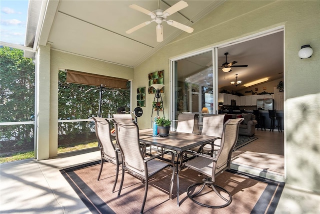 sunroom featuring vaulted ceiling and ceiling fan