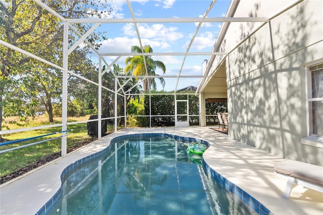 view of swimming pool featuring a lanai and a patio