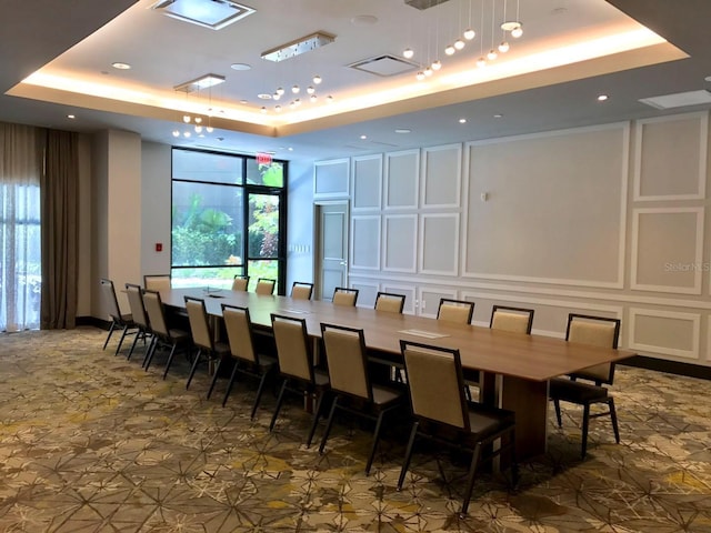 tiled dining room featuring a tray ceiling