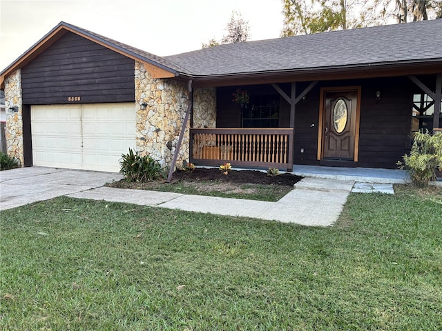 single story home featuring covered porch, a garage, and a front lawn