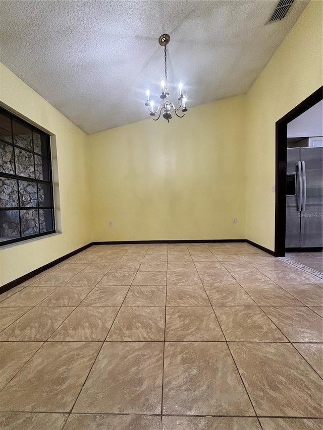 unfurnished dining area with lofted ceiling, a textured ceiling, and a chandelier