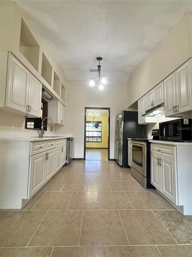 kitchen featuring a textured ceiling, stainless steel appliances, sink, a notable chandelier, and white cabinets