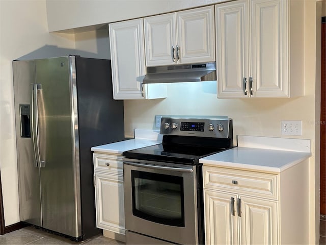 kitchen featuring appliances with stainless steel finishes, white cabinetry, and light tile patterned floors