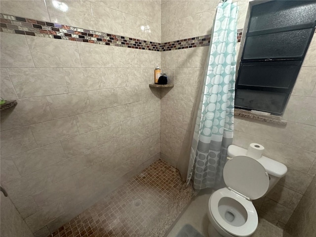 bathroom with a shower with curtain, toilet, and tile walls