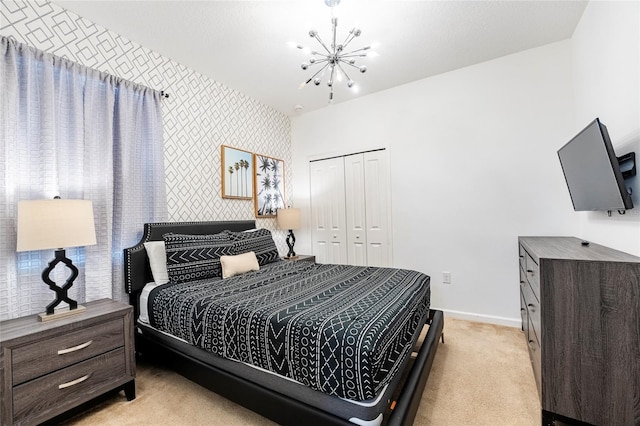 bedroom with light carpet, a chandelier, and a closet