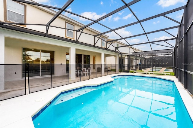 view of pool featuring a patio and glass enclosure