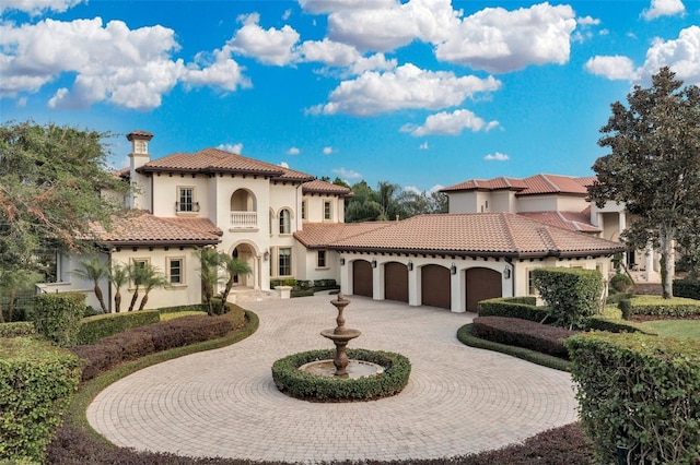 mediterranean / spanish house featuring a balcony and a garage