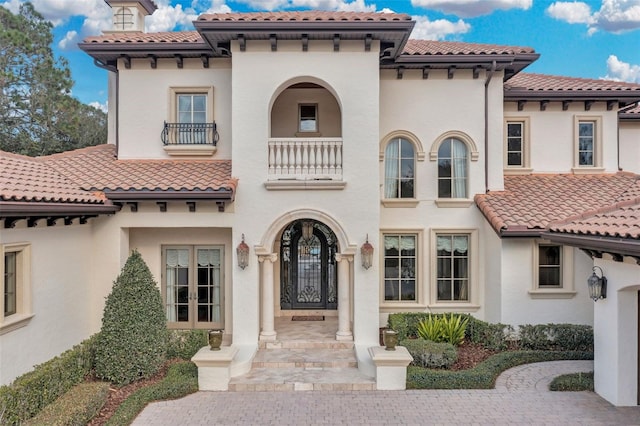 mediterranean / spanish-style home featuring a balcony