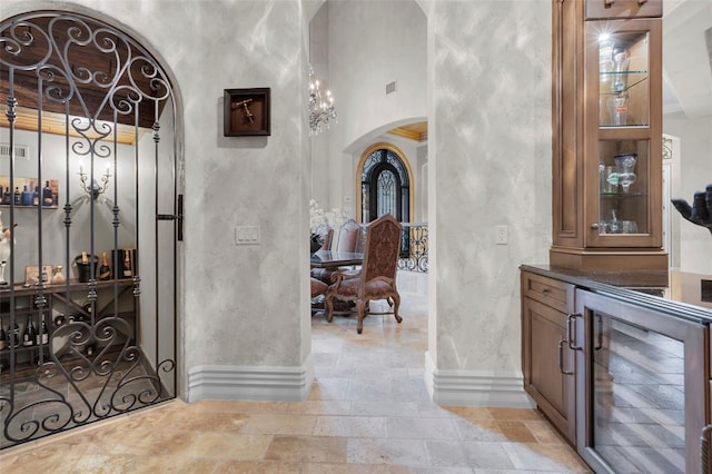 hall featuring a towering ceiling and wine cooler