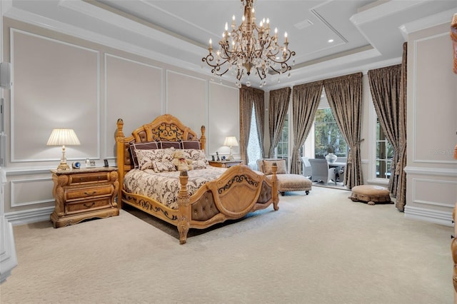 carpeted bedroom with a tray ceiling, an inviting chandelier, and ornamental molding