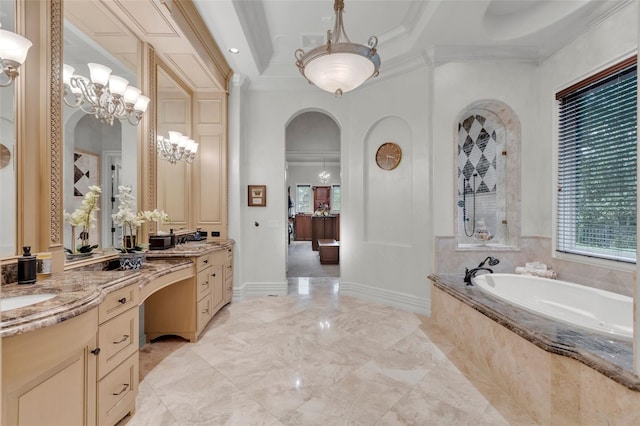 bathroom with tiled tub, crown molding, vanity, and a chandelier