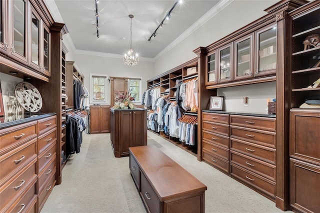 spacious closet with light colored carpet and an inviting chandelier