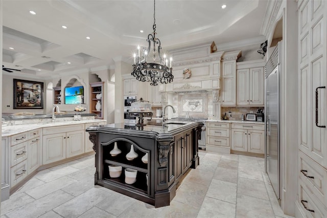 kitchen featuring decorative backsplash, coffered ceiling, pendant lighting, beamed ceiling, and an island with sink