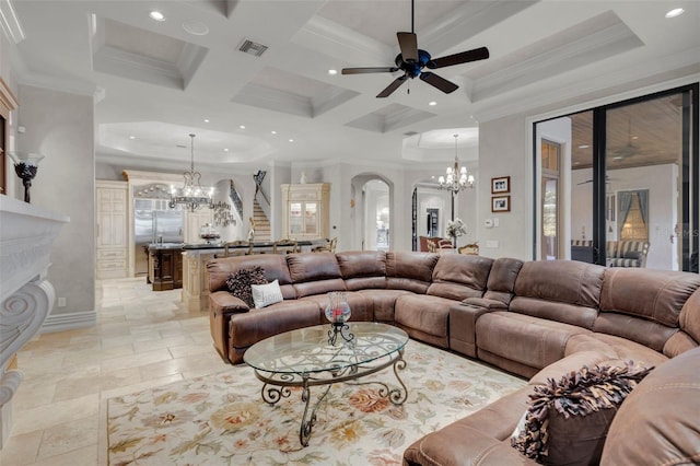 living room featuring beamed ceiling, ceiling fan with notable chandelier, ornamental molding, and coffered ceiling