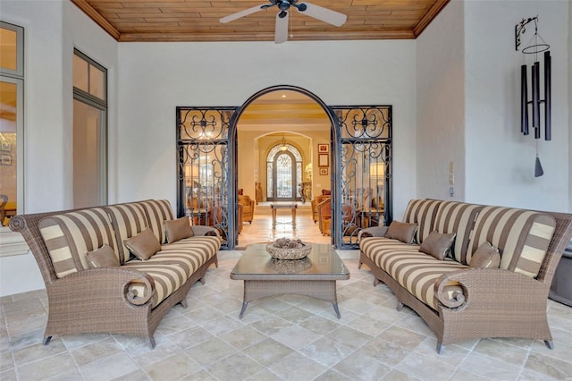 living room with crown molding, ceiling fan, and wooden ceiling