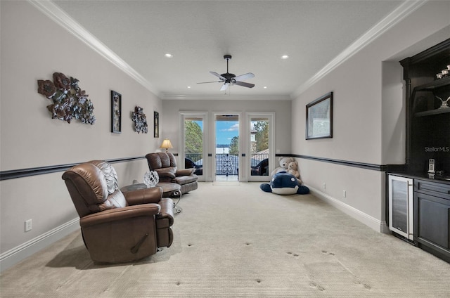 living room featuring ceiling fan, french doors, light colored carpet, and ornamental molding