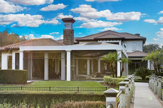 rear view of house featuring a lawn