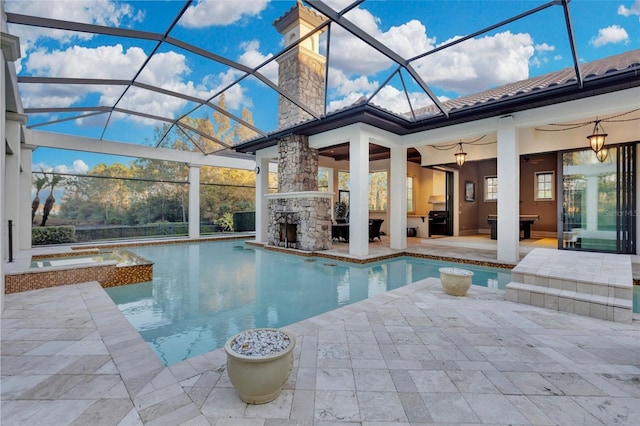 view of pool featuring ceiling fan, a lanai, a fireplace, an in ground hot tub, and a patio area