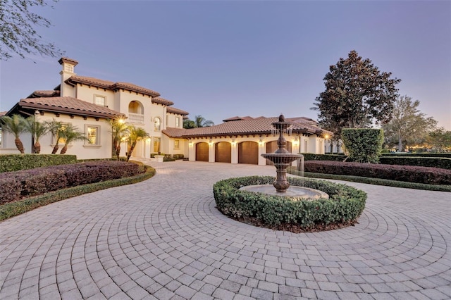 mediterranean / spanish home featuring a garage