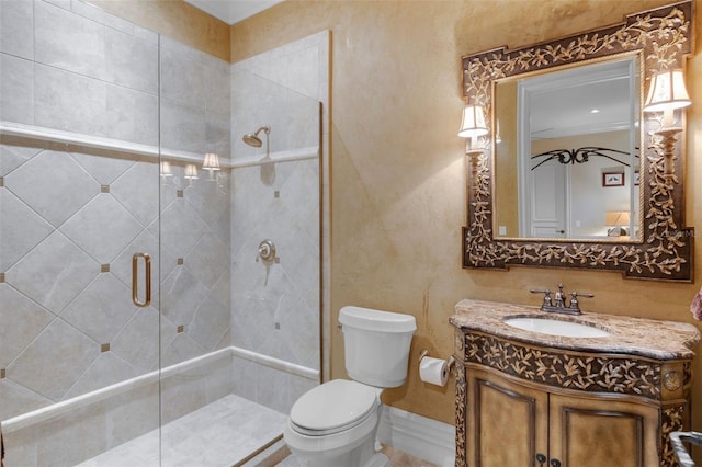 bathroom featuring vanity, toilet, and an enclosed shower