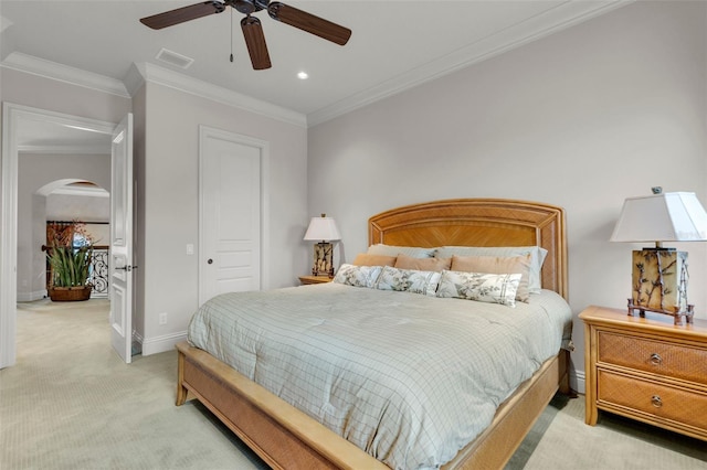 bedroom with ceiling fan, a closet, light colored carpet, and ornamental molding