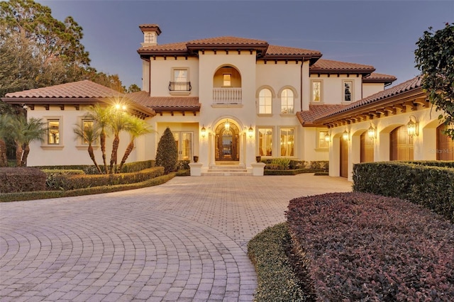 mediterranean / spanish home featuring a garage